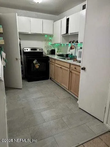 a kitchen with stainless steel appliances a sink and a stove