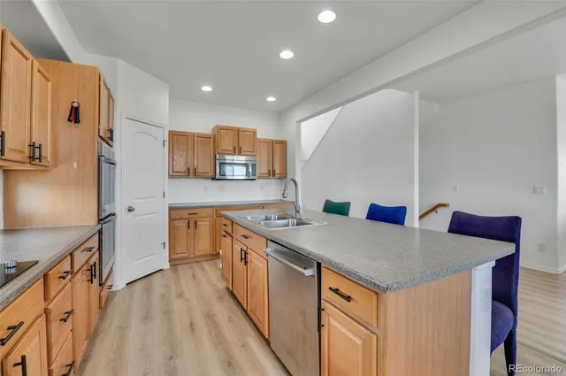 a kitchen with a sink refrigerator and microwave