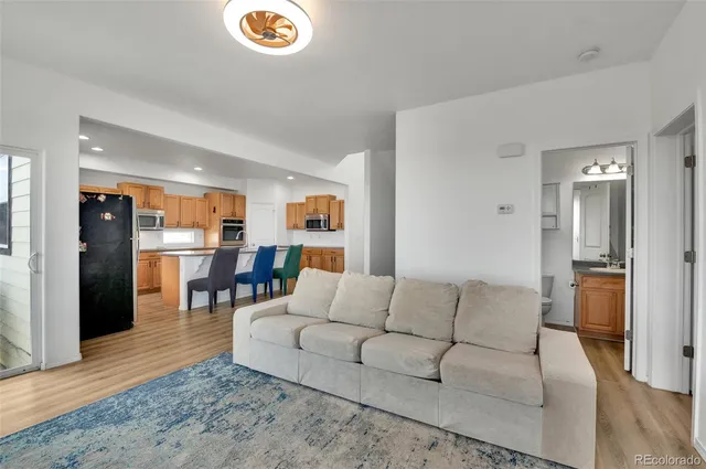 a living room with furniture and kitchen view