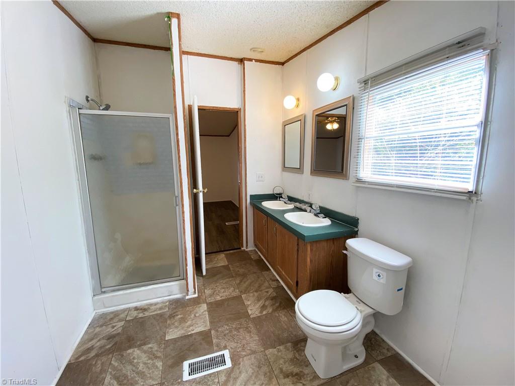 275 Reginald Road Mayodan, NC 27027 - Photo 17 of 43 Primary bath with dual sinks and separate shower
