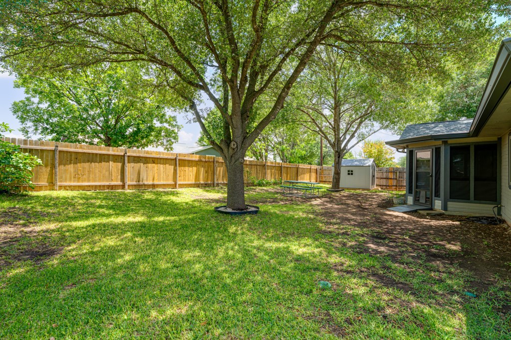 1502 Quail Run Road Pflugerville, TX 78660 - Photo 27 of 37 A spacious backyard with mature trees provides ample shade and privacy for outdoor enjoyment.