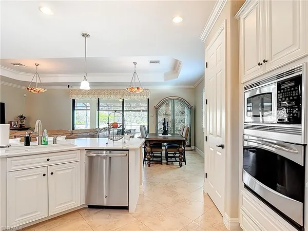 a kitchen with a stove and white cabinets