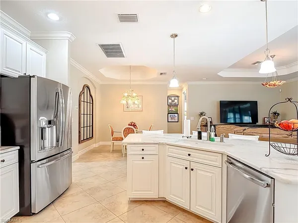 a kitchen with stainless steel appliances a refrigerator sink and cabinets