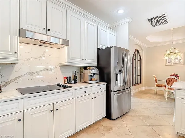 a kitchen with stainless steel appliances granite countertop a refrigerator sink and cabinets