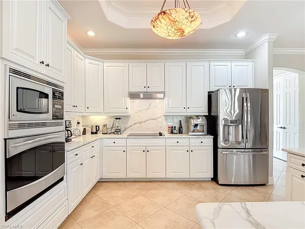 a kitchen with cabinets stainless steel appliances and a counter space