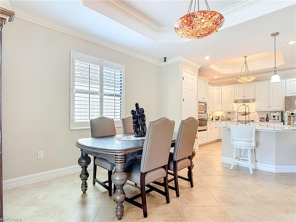 9250 Veneto Place Naples, FL 34113 - Photo 27 of 50 a view of a dining room with furniture window and outside view