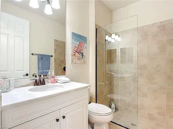 a bathroom with a sink a toilet a shower and a mirror