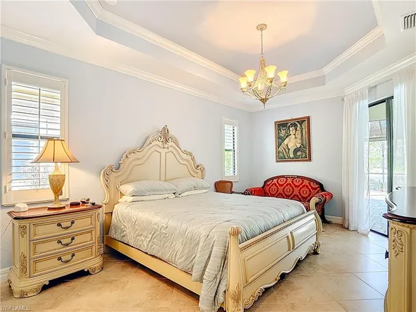 a bedroom with a bed and a chandelier