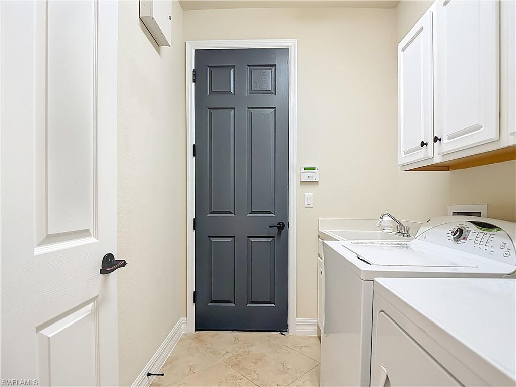 9250 Veneto Place Naples, FL 34113 - Photo 42 of 50 a bathroom with a sink and a mirror