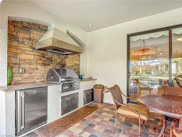 a kitchen with a stove a sink and chairs
