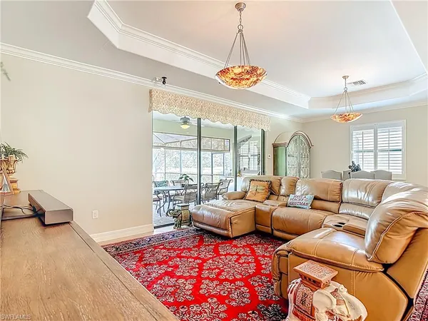 a living room with furniture chandelier and a table