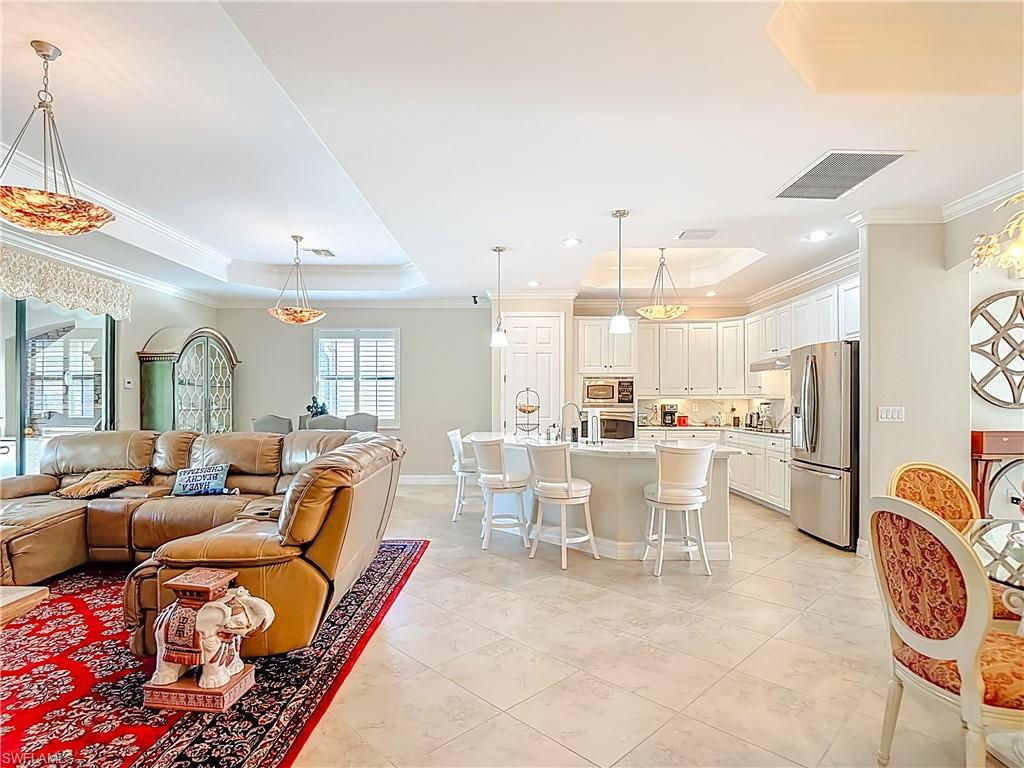 9250 Veneto Place Naples, FL 34113 - Photo 10 of 50 a living room with lots of furniture and a table
