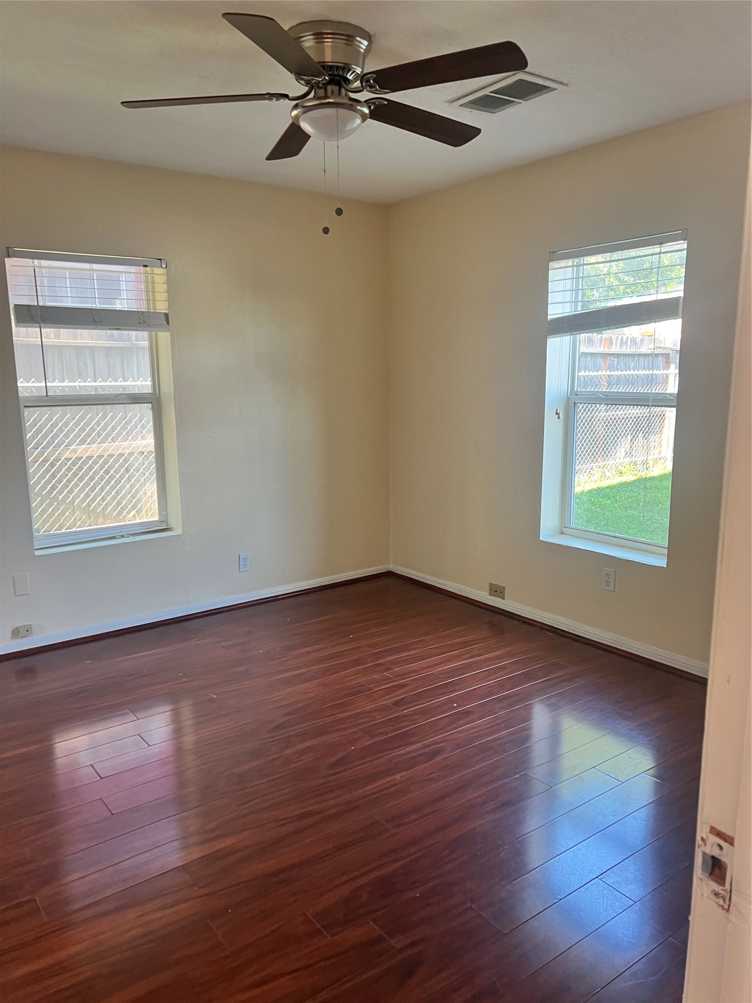 5604 Chapman Street Houston, TX 77009 - Photo 13 of 25 an empty room with wooden floor closet and windows