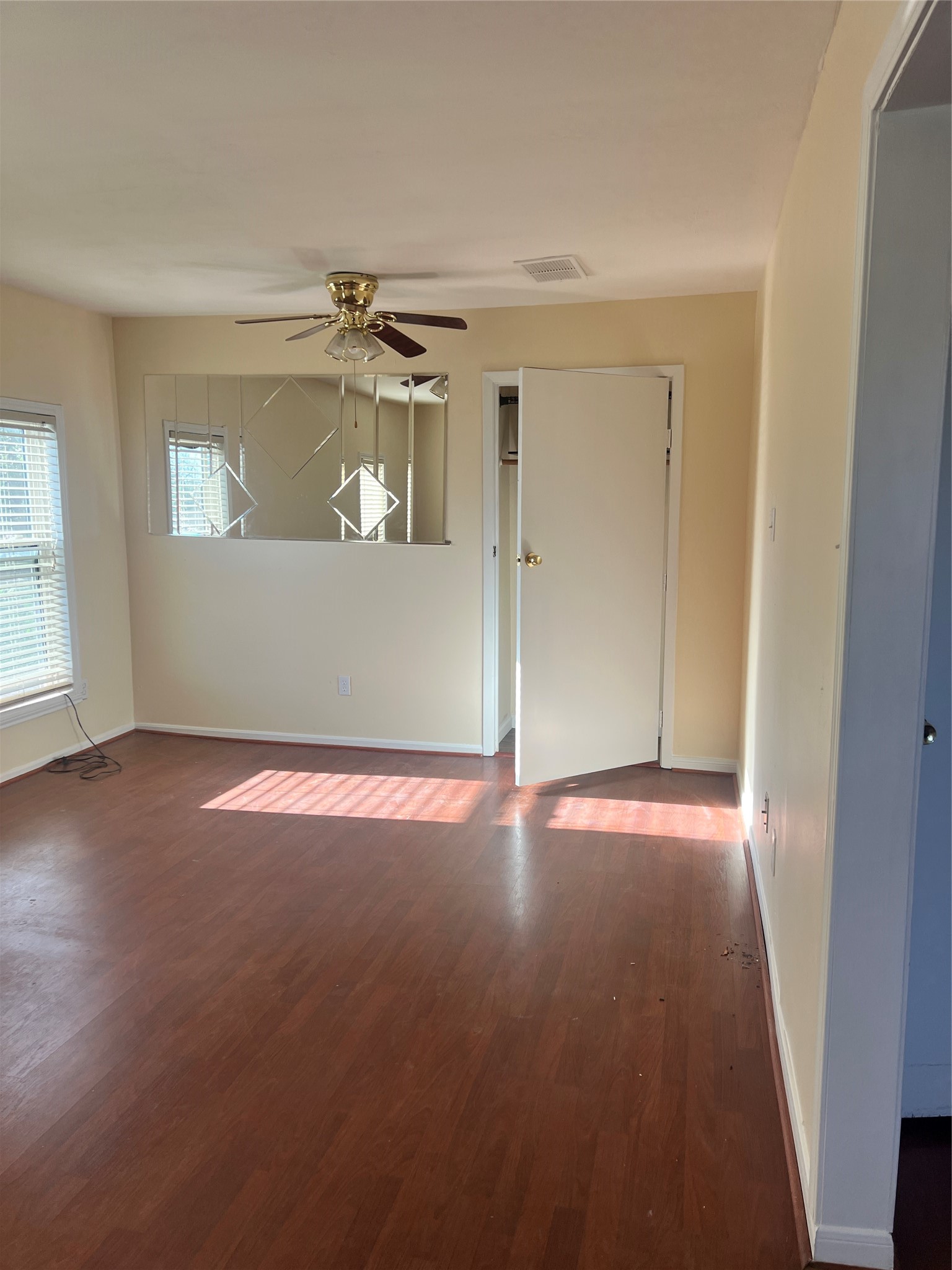 5604 Chapman Street Houston, TX 77009 - Photo 14 of 25 an empty room with wooden floor and windows