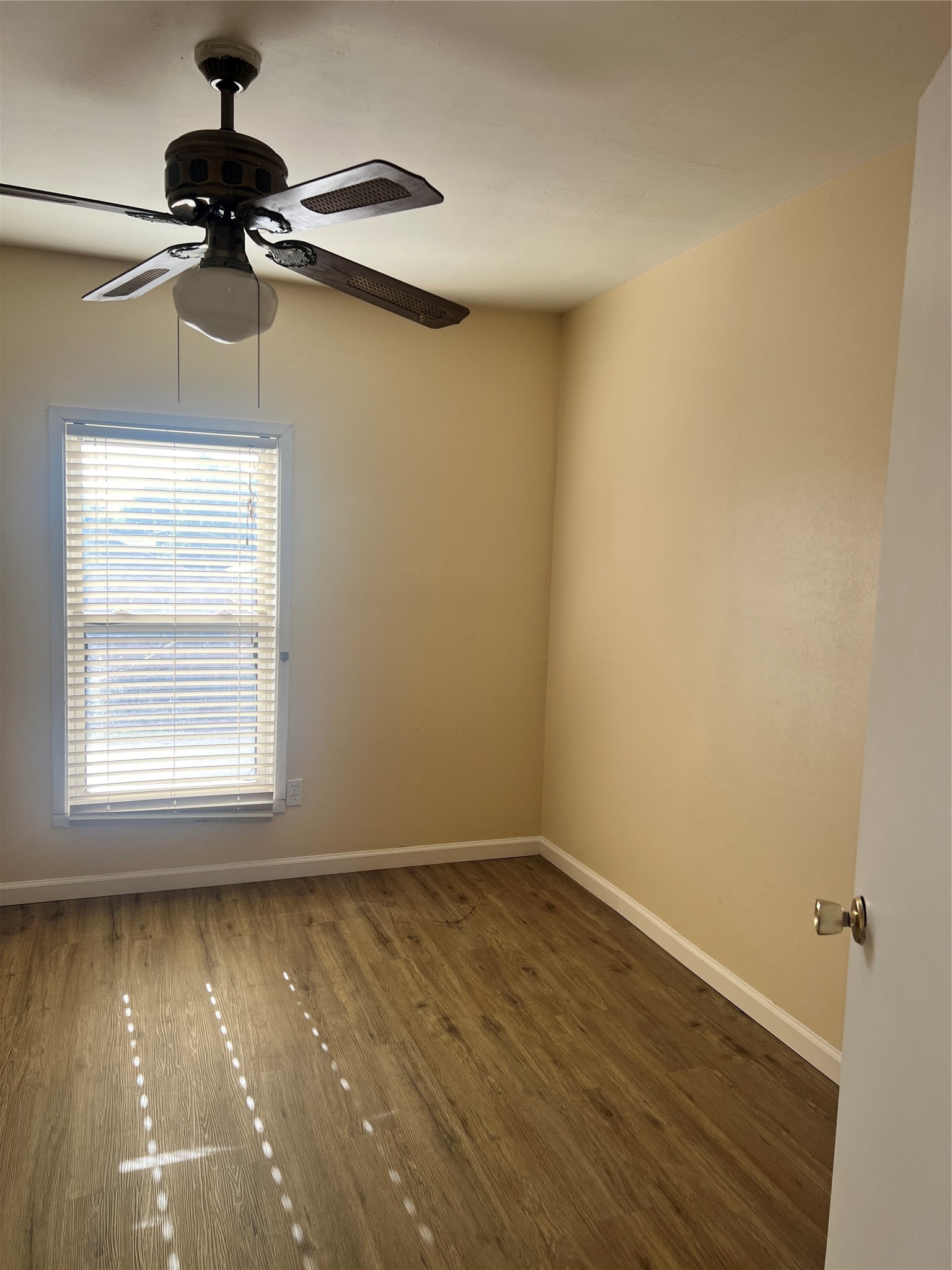 5604 Chapman Street Houston, TX 77009 - Photo 21 of 25 a view of a room with a window and wooden floor