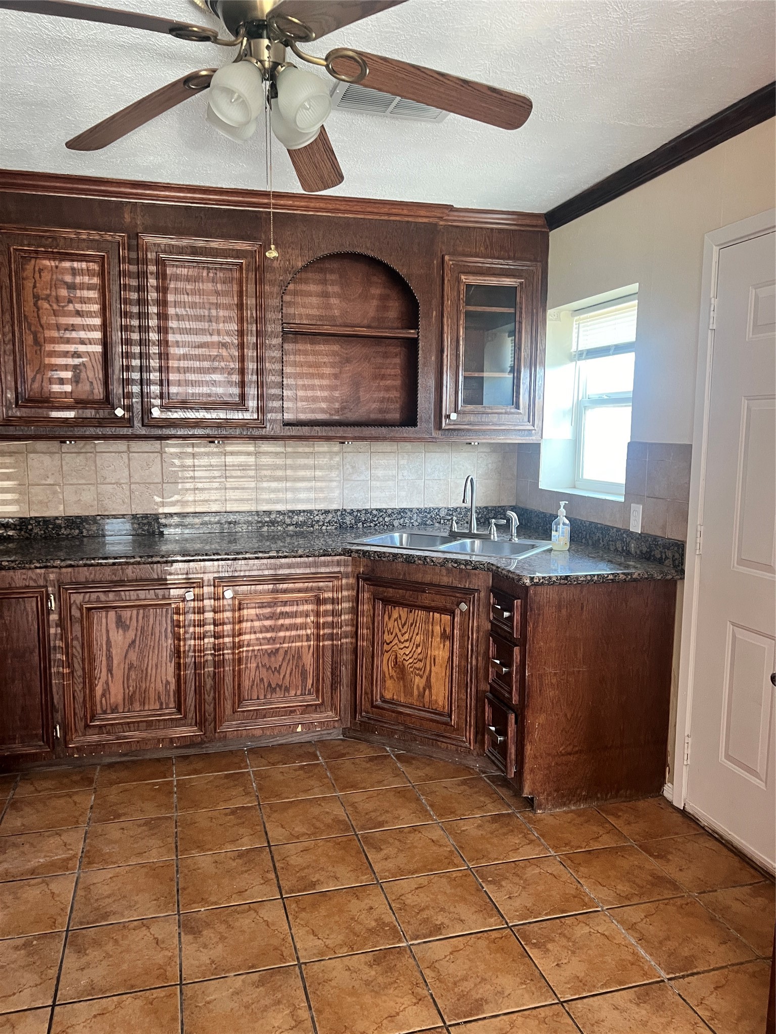 5604 Chapman Street Houston, TX 77009 - Photo 6 of 25 a kitchen with granite countertop a stove a sink and a microwave