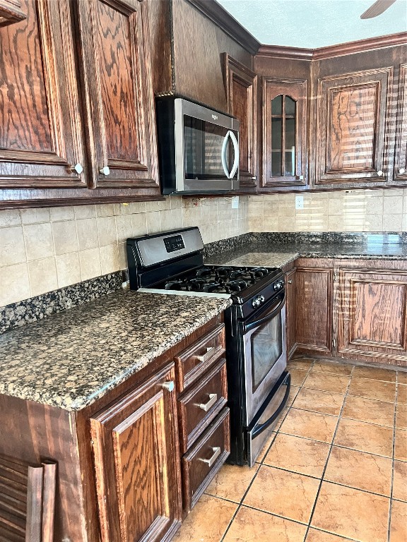 5604 Chapman Street Houston, TX 77009 - Photo 7 of 25 a kitchen with stainless steel appliances granite countertop a stove a microwave and a sink