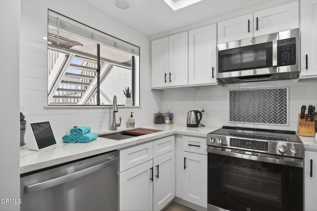 2955 Harbor Boulevard Oxnard, CA 93035 - Photo 15 of 41 a kitchen with a sink stove and microwave