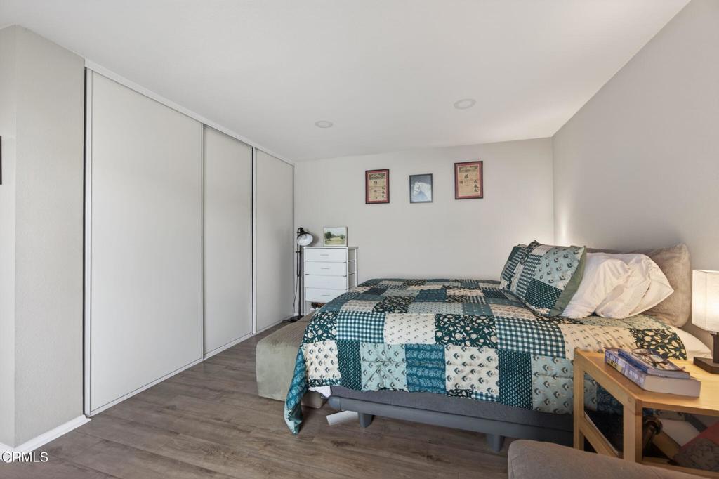 2955 Harbor Boulevard Oxnard, CA 93035 - Photo 18 of 41 a bed sitting in a bedroom next to a window with wooden floor