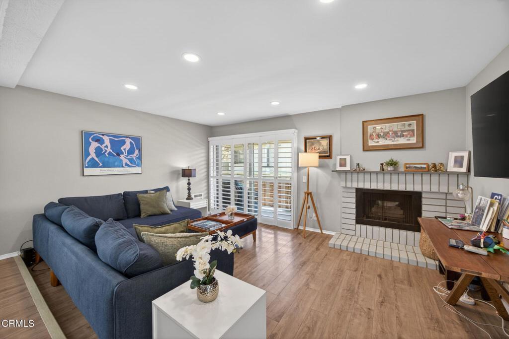 2955 Harbor Boulevard Oxnard, CA 93035 - Photo 8 of 41 a living room with furniture a fireplace and a flat screen tv
