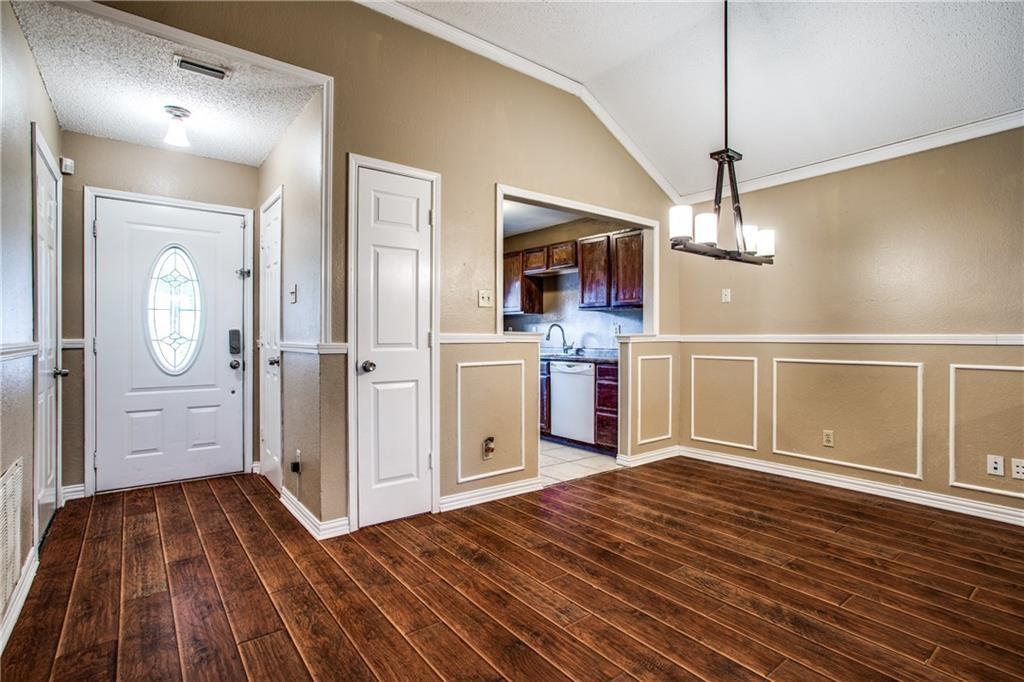 6817 Haltom Road Fort Worth, TX 76137 - Photo 21 of 25 Entryway and dining area featuring wood-finish flooring