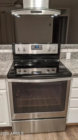 a stove top oven sitting inside of a kitchen