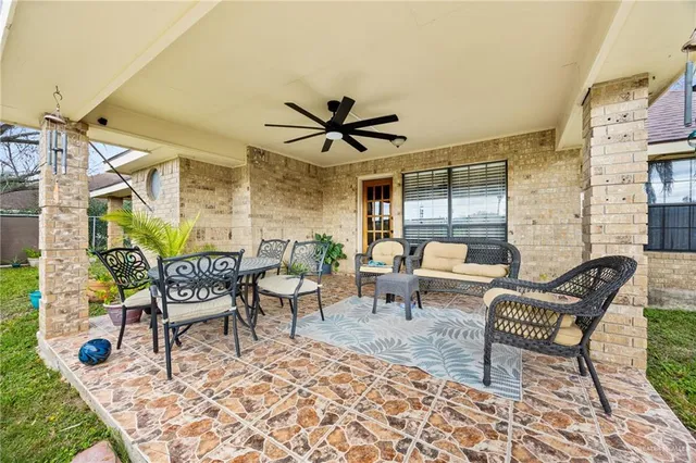 a balcony with couch and a potted plant