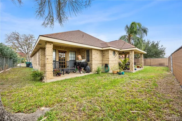 a view of a house with backyard and sitting area