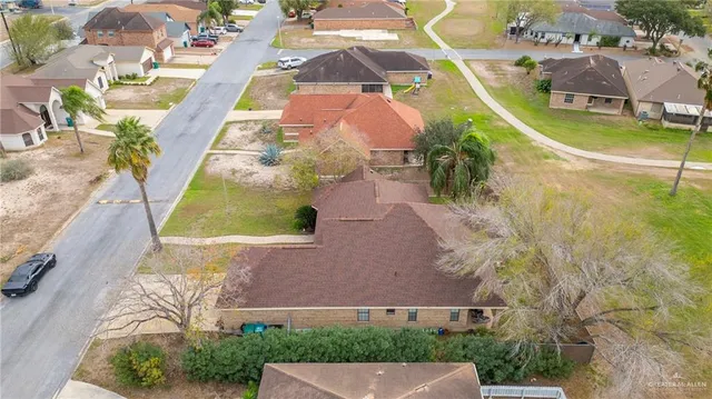 an aerial view of residential houses with outdoor space