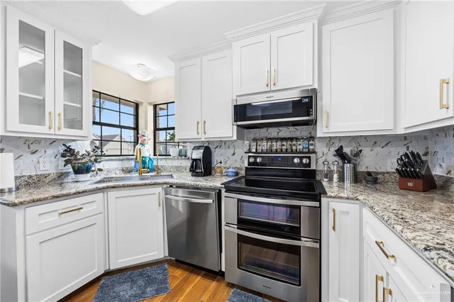 a kitchen with cabinets stainless steel appliances and wooden cabinets