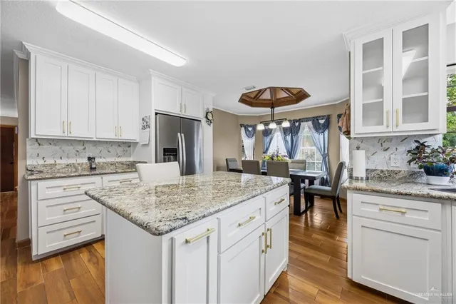 a kitchen with a stove a sink and a refrigerator