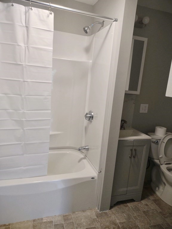 31 Edwards Street, Unit 2F Fitchburg, MA 01420 - Photo 4 of 5 a bathroom with a bathtub a toilet and a shower