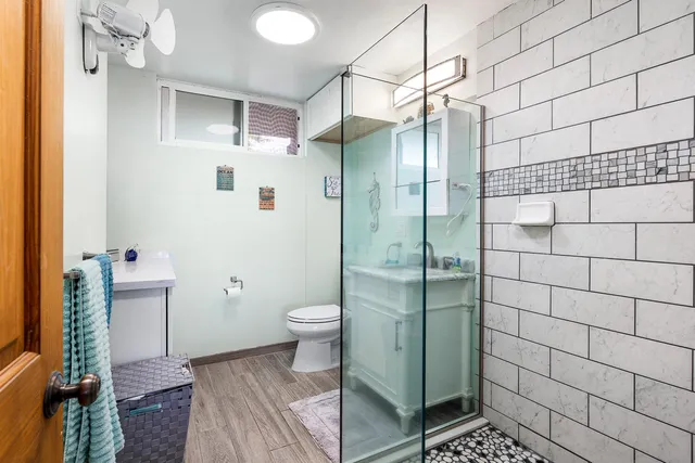 a bathroom with a toilet a sink and shower