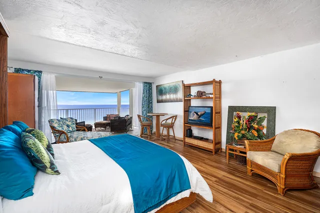 a bedroom with furniture and a wooden floor
