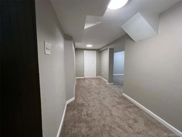 a view of hallway with an empty room