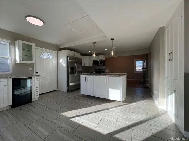 an open kitchen with a refrigerator and a stove