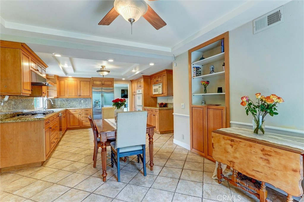 19238 Castlebay Lane Porter Ranch, CA 91326 - Photo 13 of 38 a dining room filled chandelier and kitchen view