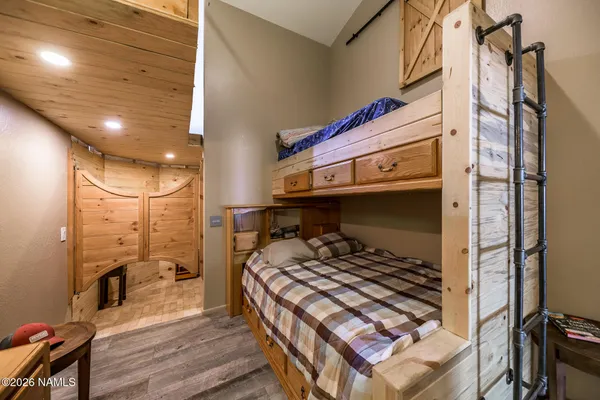 a bathroom with a toilet a sink a mirror a window and vanity