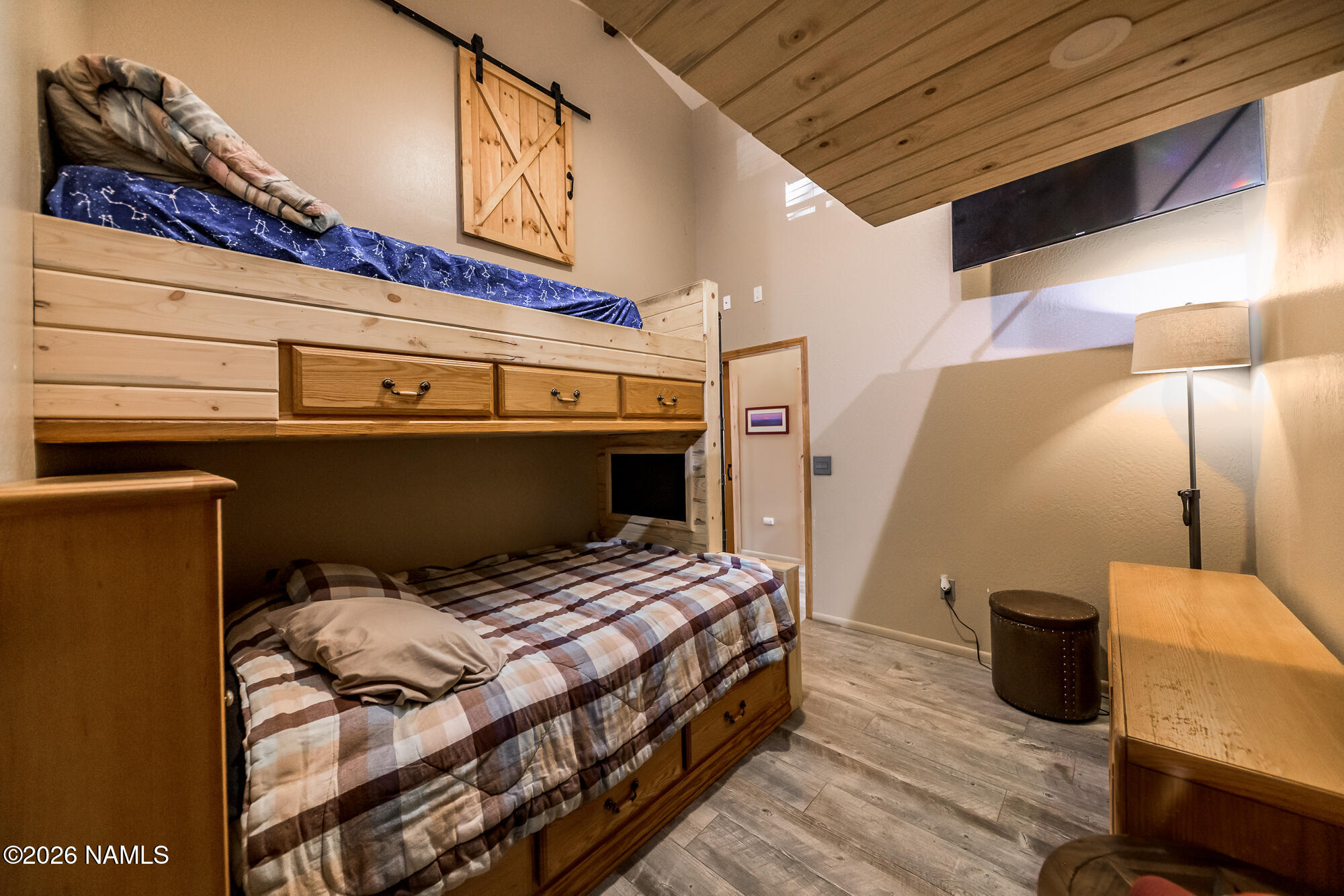 7042 East Robin Hood Road Williams, AZ 86046 - Photo 20 of 58 a bedroom with a bed and wooden floor