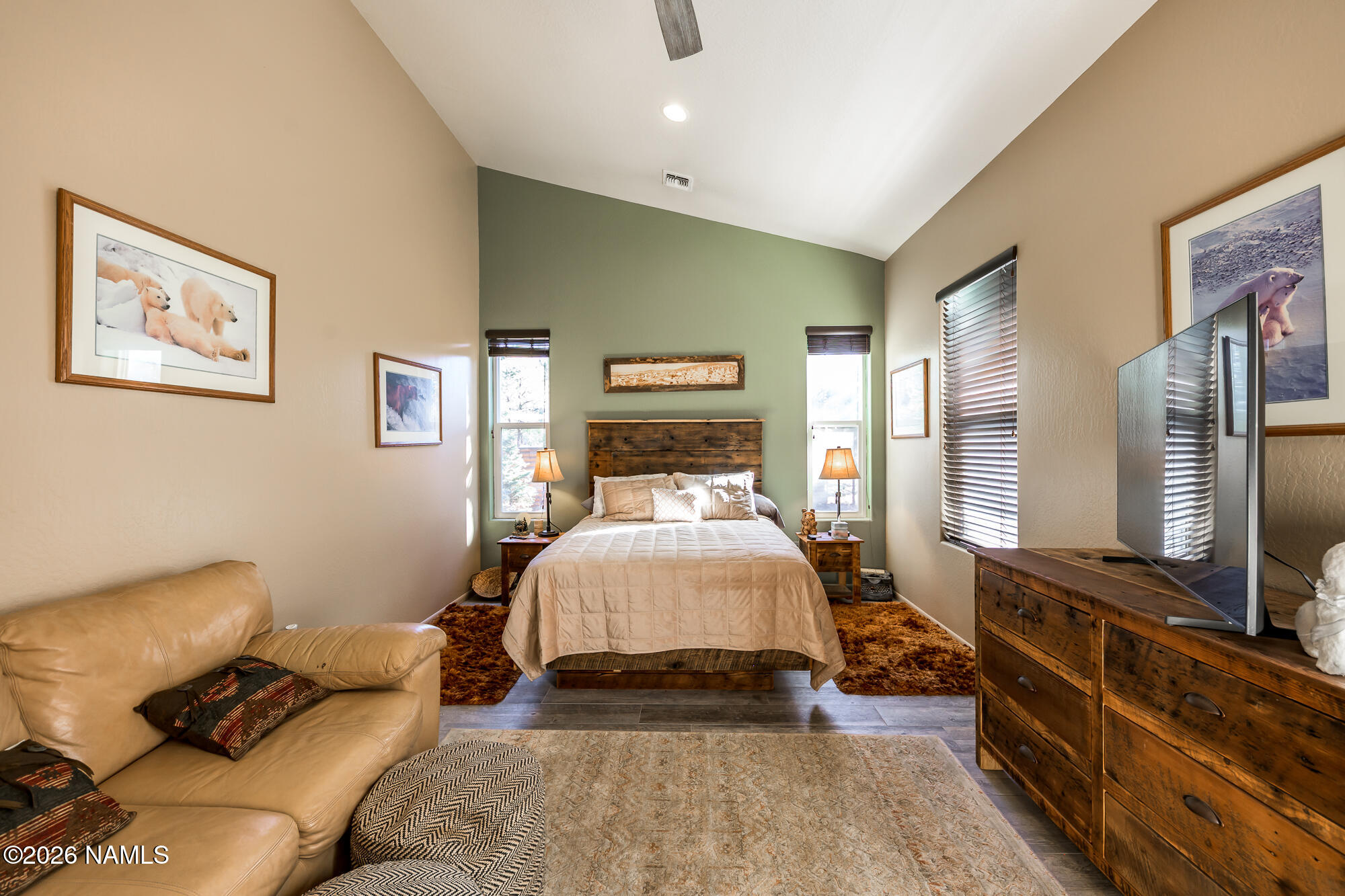 7042 East Robin Hood Road Williams, AZ 86046 - Photo 24 of 58 a spacious bedroom with a bed and wooden floor