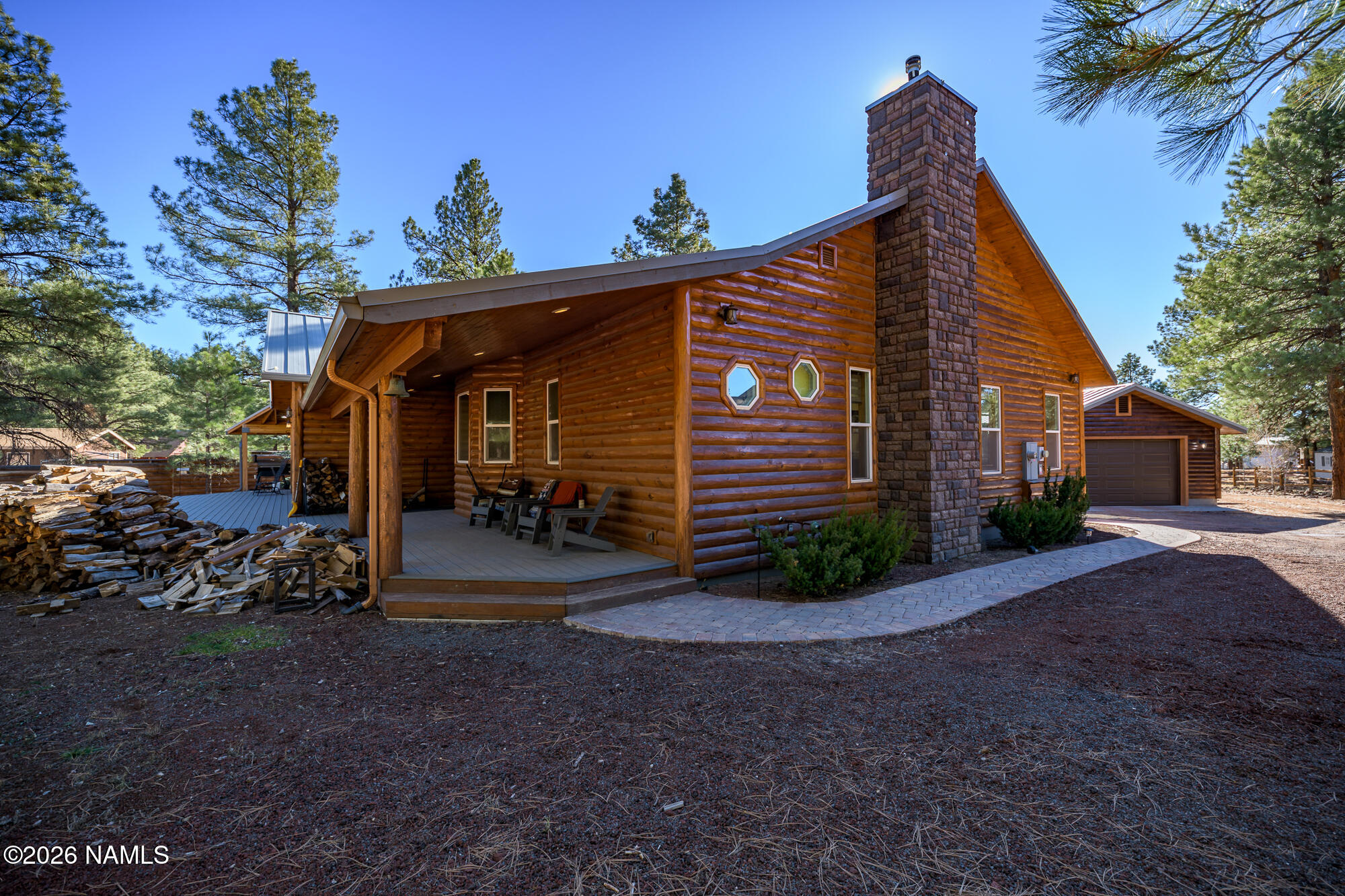 7042 East Robin Hood Road Williams, AZ 86046 - Photo 30 of 58 a view of a house with a yard and a large tree