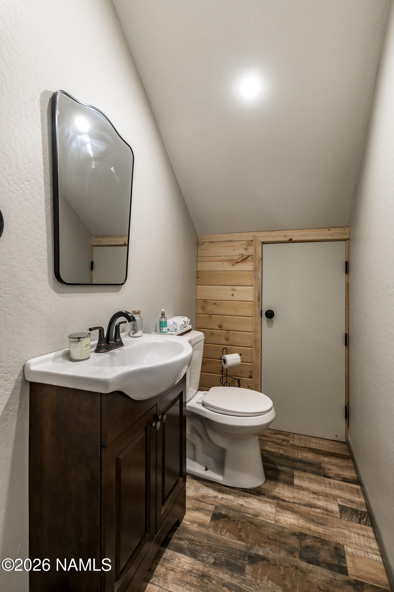 7042 East Robin Hood Road Williams, AZ 86046 - Photo 39 of 58 a bathroom with a toilet sink and mirror