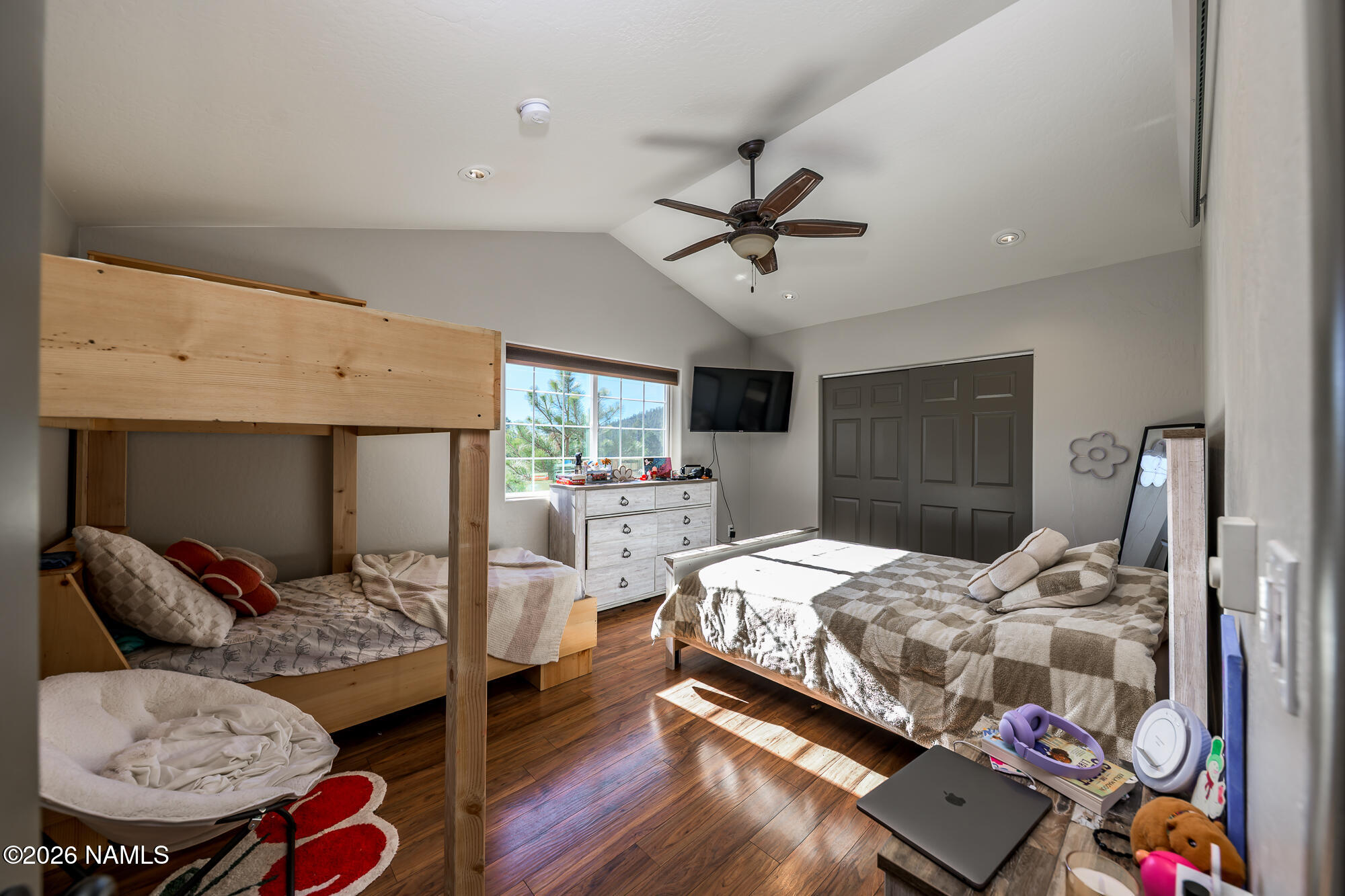 7042 East Robin Hood Road Williams, AZ 86046 - Photo 43 of 58 a bedroom with a bed and wooden floor