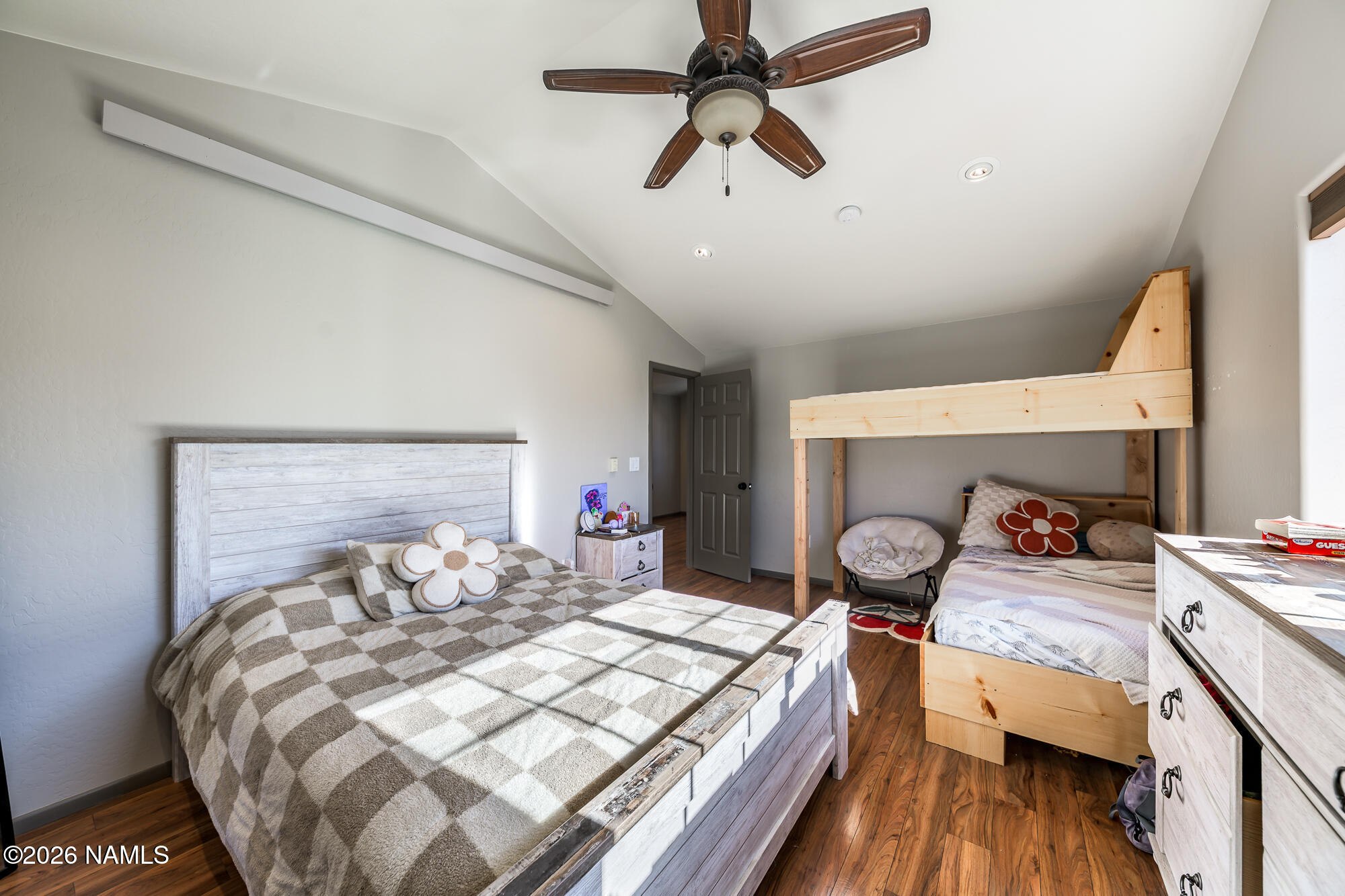 7042 East Robin Hood Road Williams, AZ 86046 - Photo 44 of 58 a bedroom with a bed and a chandelier