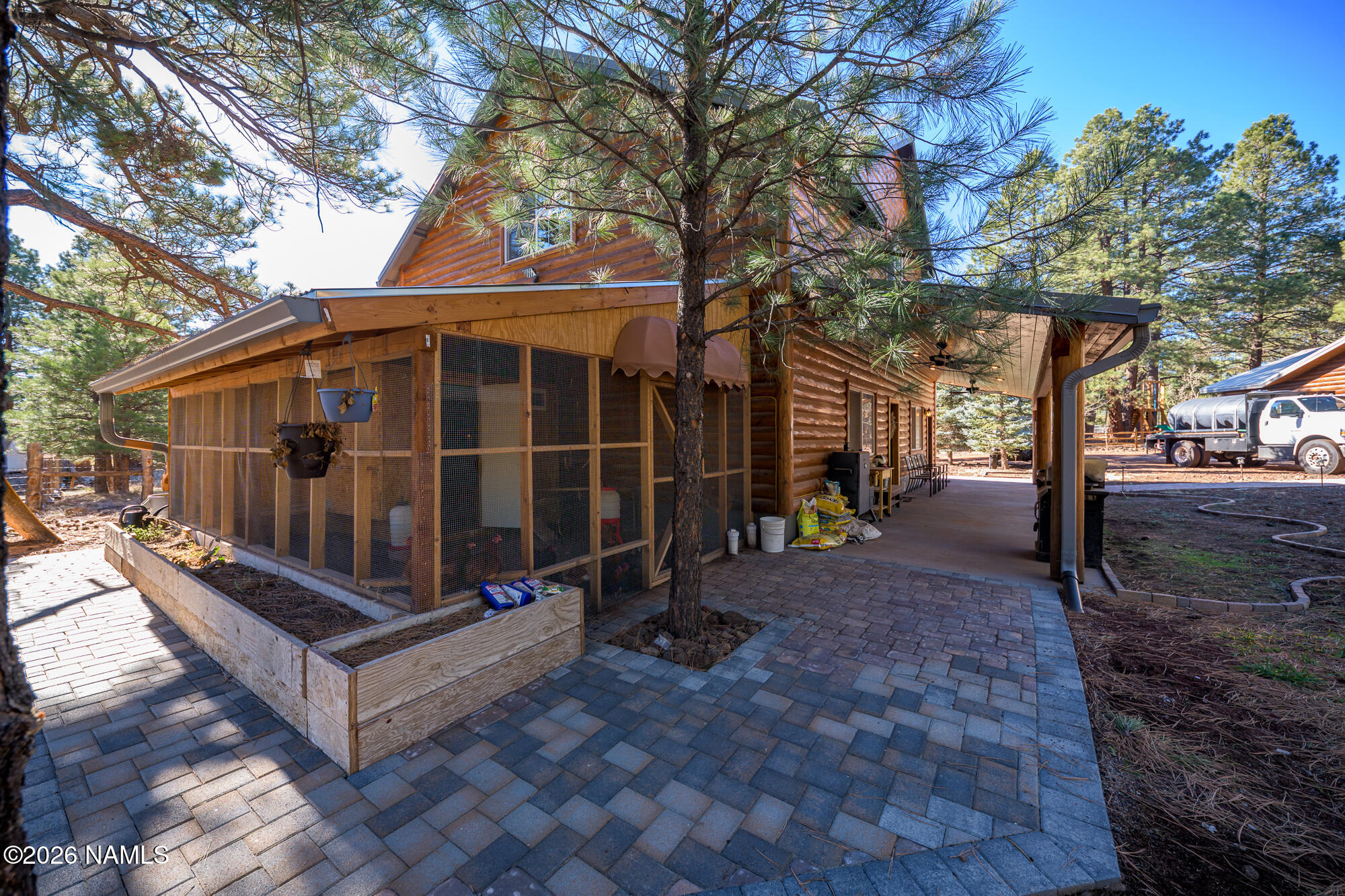 7042 East Robin Hood Road Williams, AZ 86046 - Photo 50 of 58 a view of a small yard with wooden fence and a large tree