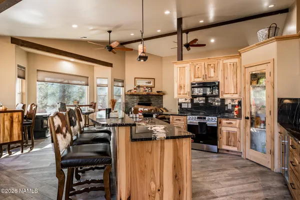a kitchen with stainless steel appliances granite countertop sink stove and large window