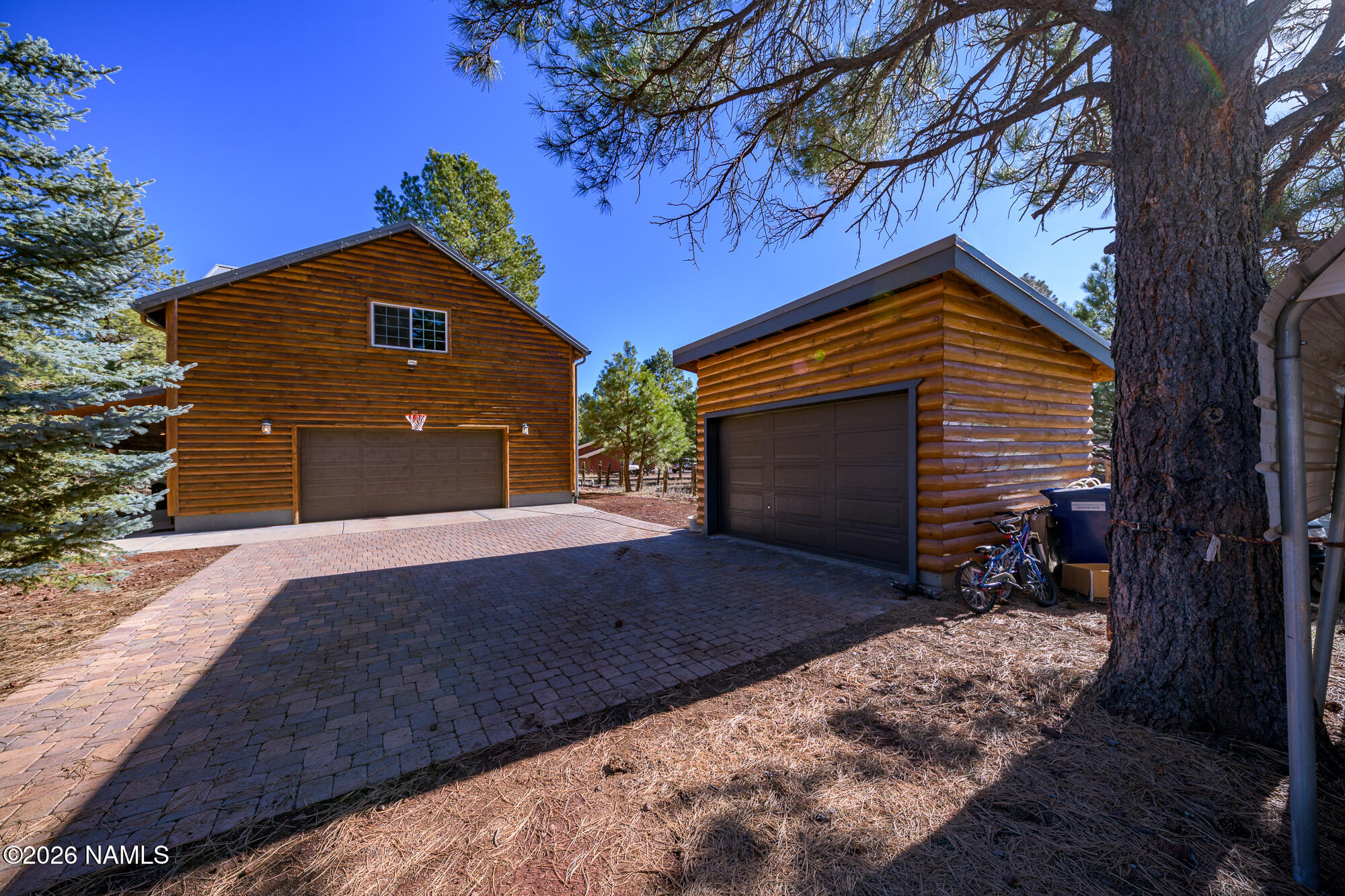 7042 East Robin Hood Road Williams, AZ 86046 - Photo 53 of 58 a front view of a house with a yard and garage