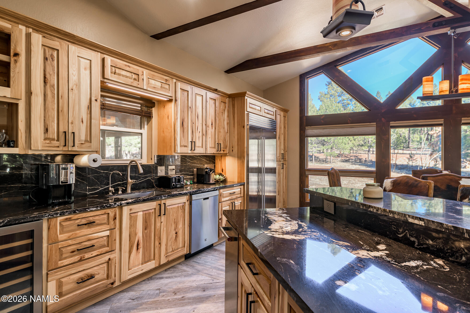 7042 East Robin Hood Road Williams, AZ 86046 - Photo 7 of 58 a kitchen with stainless steel appliances granite countertop sink stove and large window