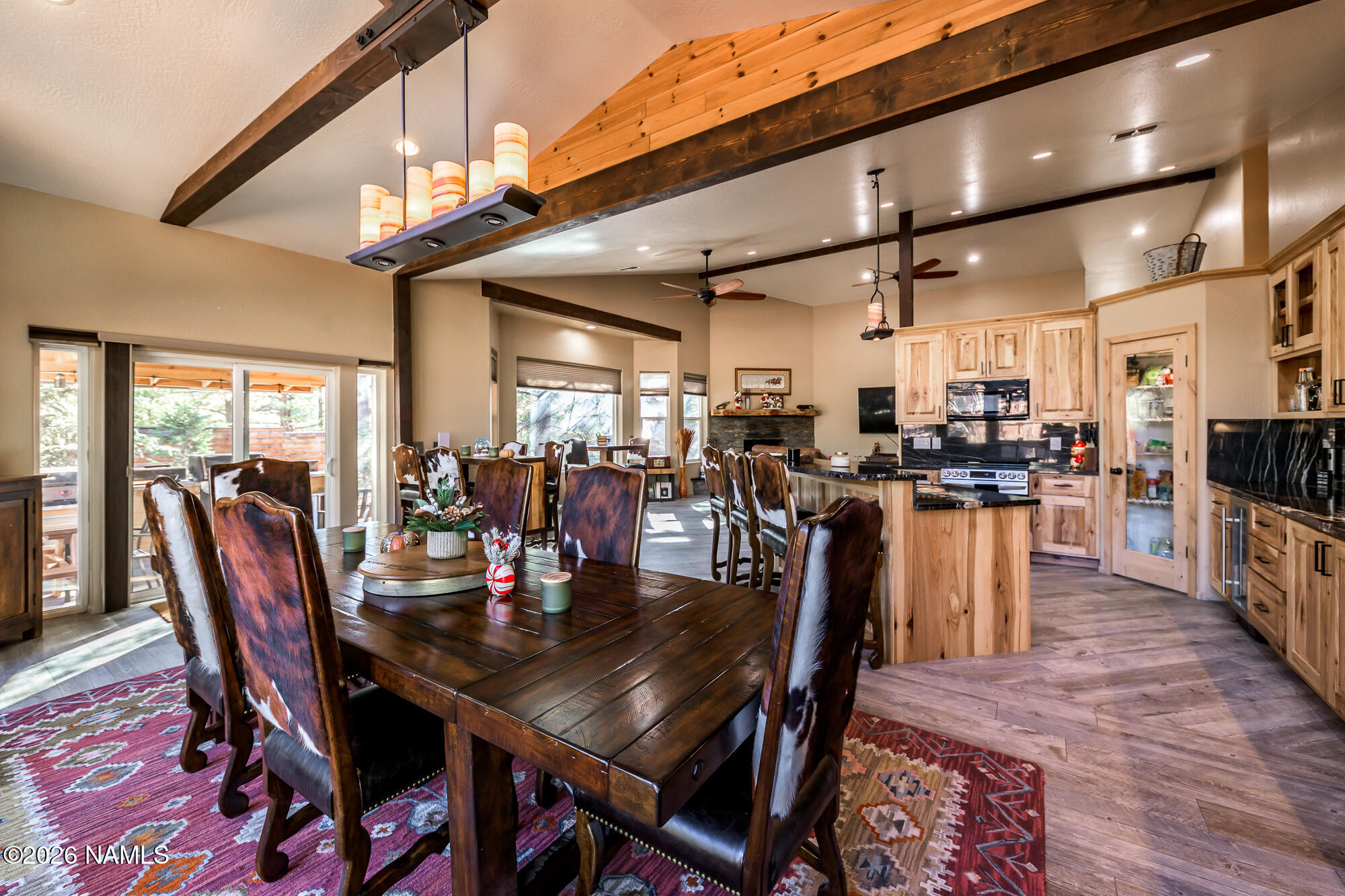 7042 East Robin Hood Road Williams, AZ 86046 - Photo 8 of 58 a dining room with stainless steel appliances granite countertop a table chairs and a living room