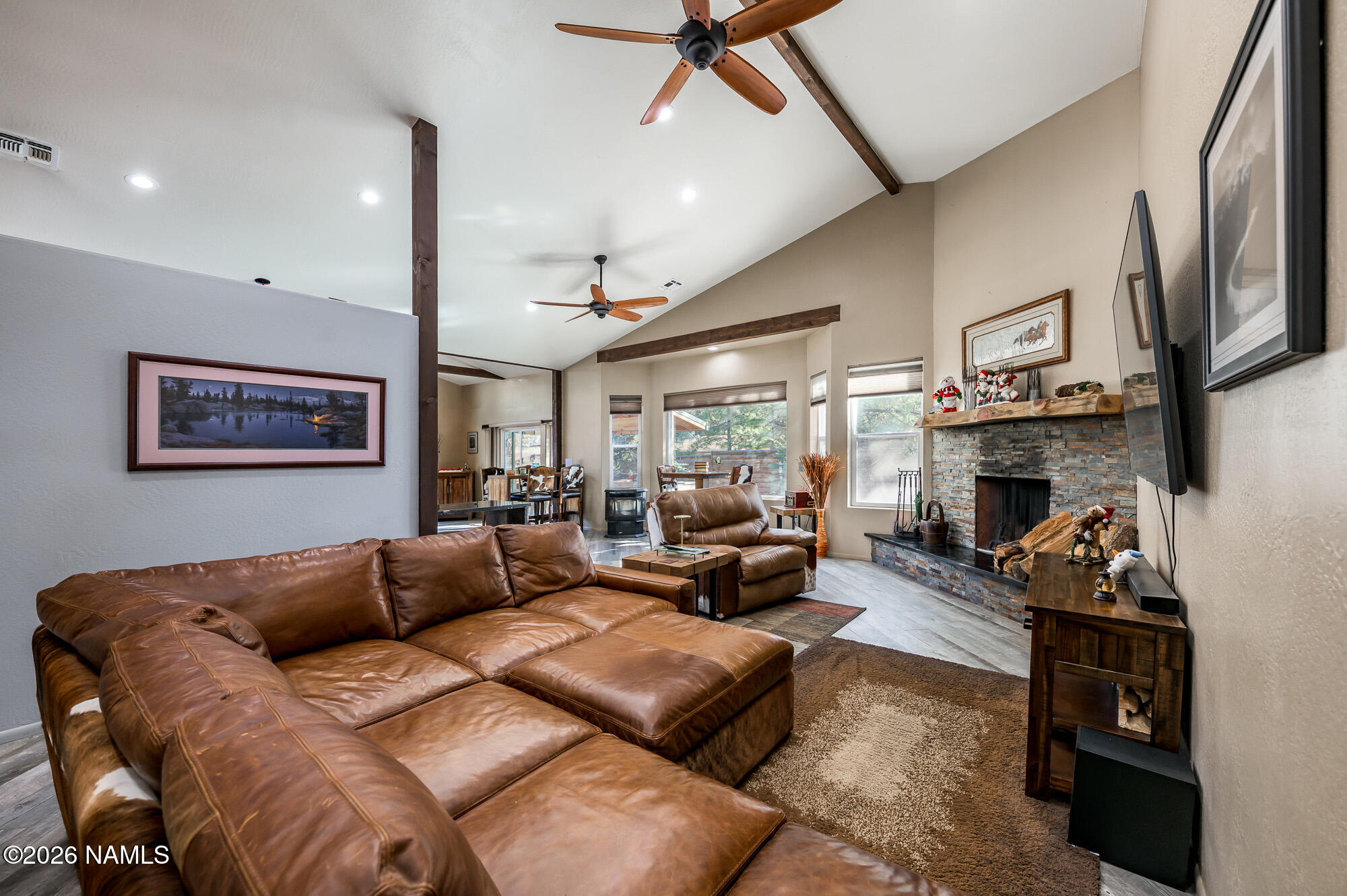 7042 East Robin Hood Road Williams, AZ 86046 - Photo 10 of 58 a living room with furniture fireplace and a flat screen tv